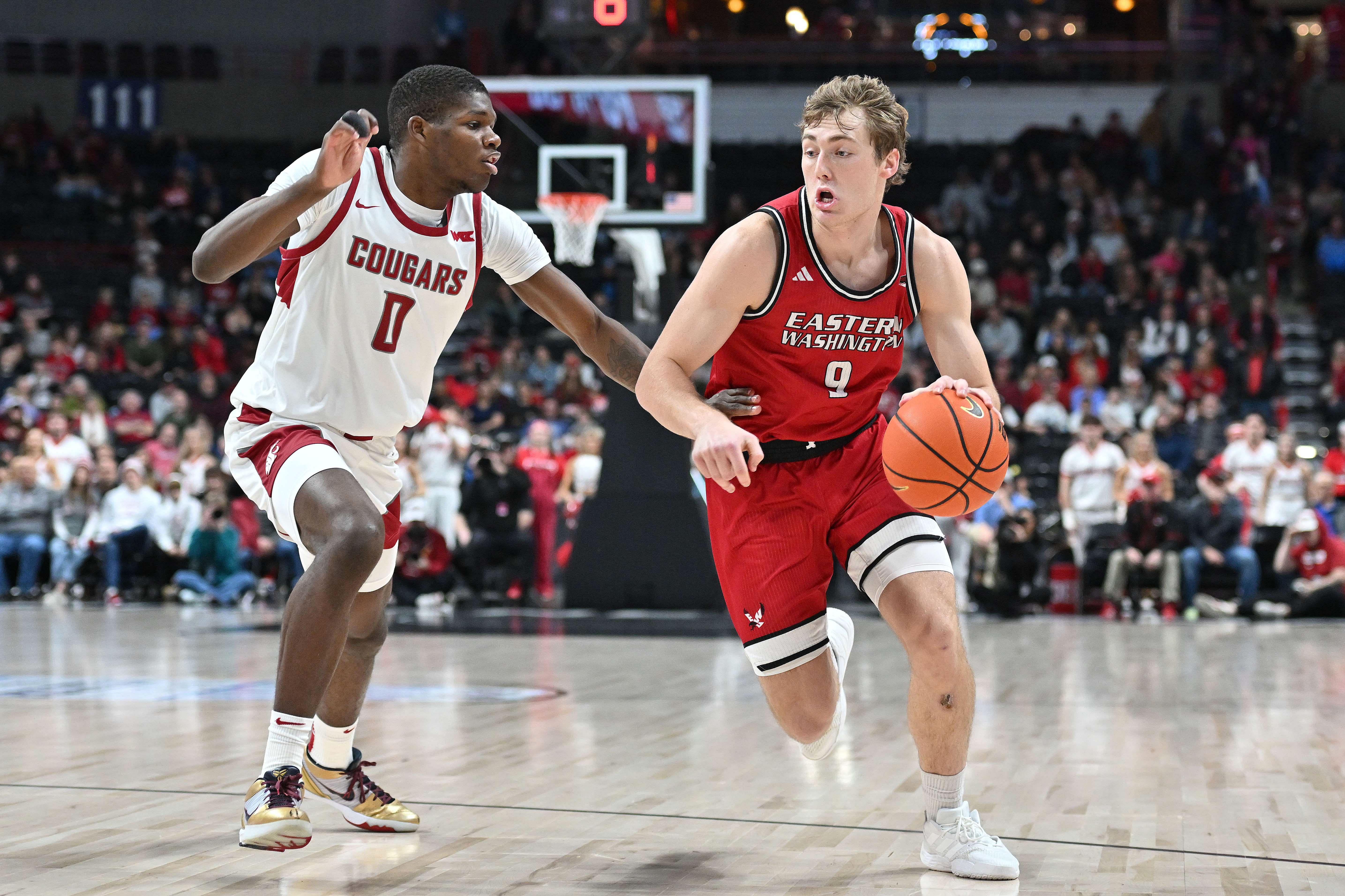 Andrew Cook (9) controls the ball against Washington State Cougars guard Cedric Coward (0) - Source: Imagn